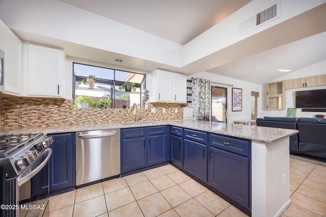 2804 W Camino Ebano, Tucson, AZ 85742 - kitchen with appliances with stainless steel finishes, a peninsula, blue cabinets, lofted ceiling, and a sink