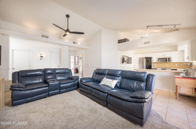 2804 W Camino Ebano, Tucson, AZ 85742 - living area with a ceiling fan, a textured ceiling, light tile patterned floors, and high vaulted ceiling
