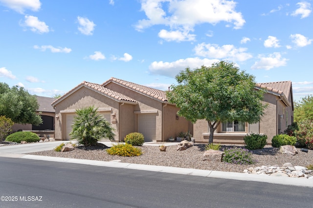 59962 E Arroyo Grande Dr, Oracle, AZ 85623 - view of front of home with an attached garage, a tiled roof, stucco siding, and driveway