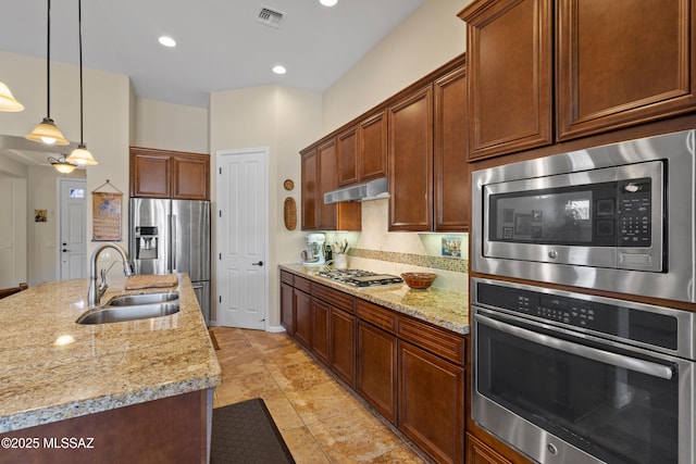 59962 E Arroyo Grande Dr, Oracle, AZ 85623 - kitchen featuring stainless steel appliances, a sink, under cabinet range hood, light stone countertops, and decorative light fixtures