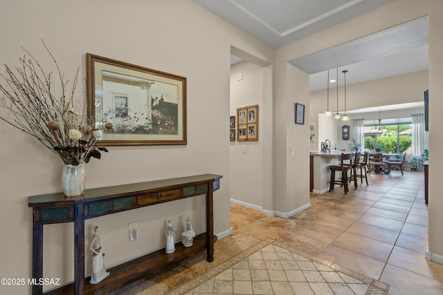 59962 E Arroyo Grande Dr, Oracle, AZ 85623 - corridor featuring baseboards and a chandelier