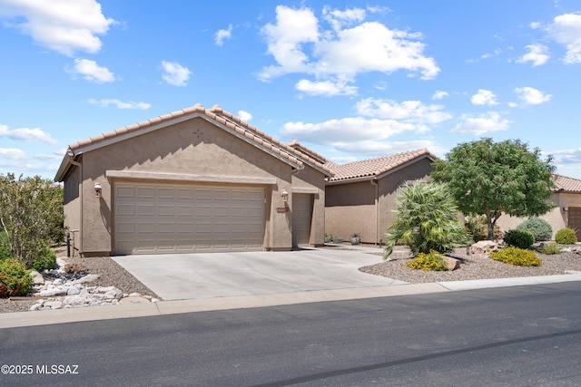 59962 E Arroyo Grande Dr, Oracle, AZ 85623 - view of front facade with stucco siding, a garage, and driveway