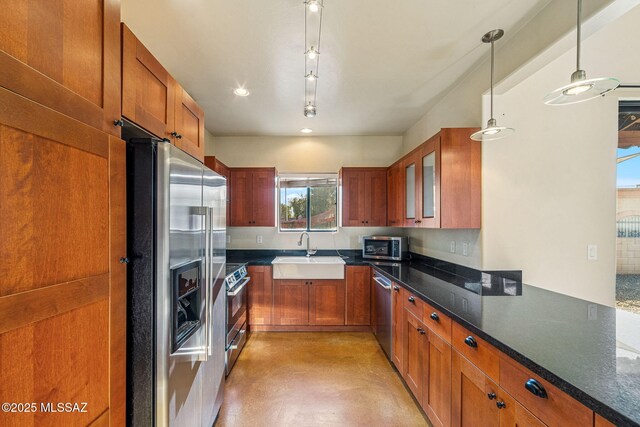 1050 E Easy St, Tucson, AZ 85719 - kitchen featuring stainless steel appliances, brown cabinets, finished concrete flooring, pendant lighting, and recessed lighting