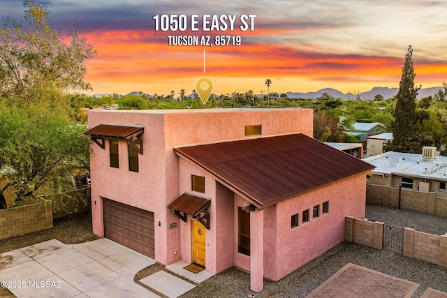 1050 E Easy St, Tucson, AZ 85719 - view of front of home featuring an attached garage, stucco siding, and a mountain view