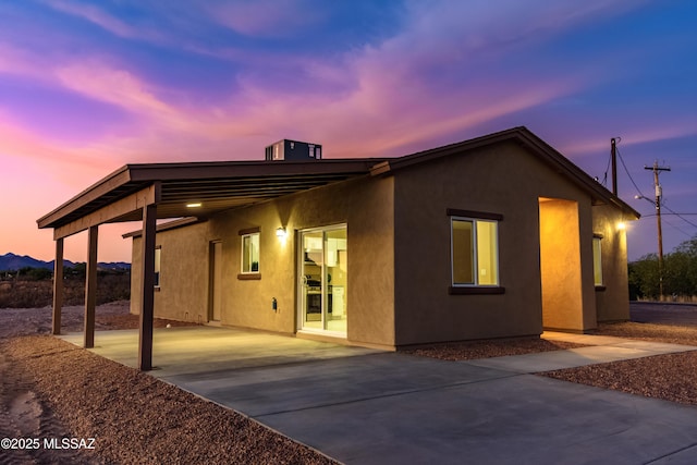 174 Via Casa, Rio Rico, AZ 85648 - back of house with stucco siding, concrete driveway, and a patio