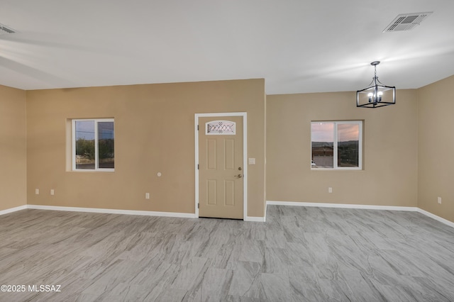 174 Via Casa, Rio Rico, AZ 85648 - entryway featuring a chandelier, baseboards, and plenty of natural light