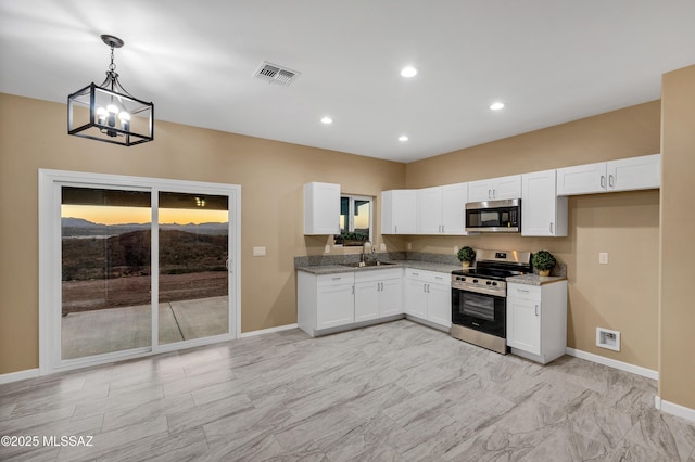 174 Via Casa, Rio Rico, AZ 85648 - kitchen featuring stainless steel appliances, baseboards, white cabinets, pendant lighting, and recessed lighting