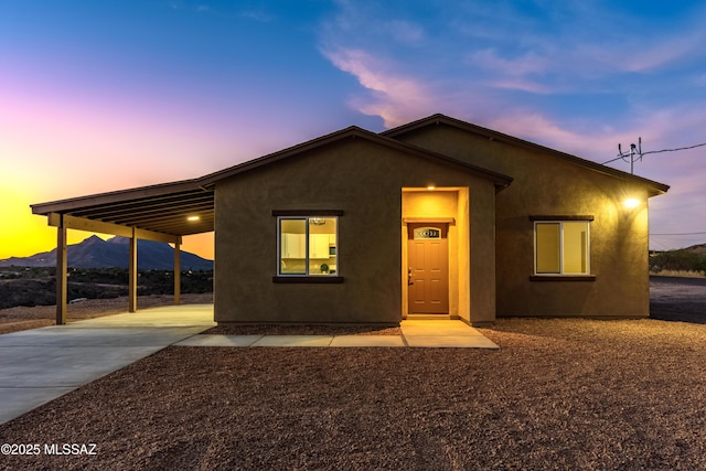 174 Via Casa, Rio Rico, AZ 85648 - ranch-style house featuring driveway, stucco siding, an attached carport, and a mountain view