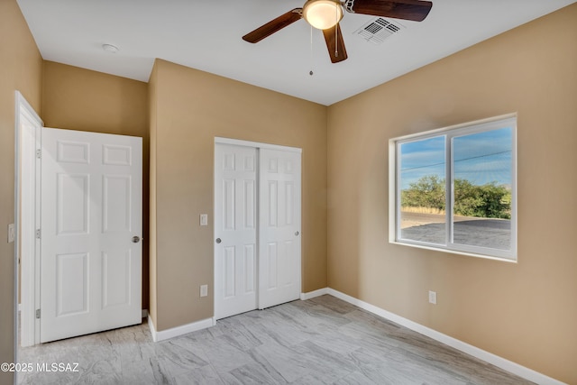 174 Via Casa, Rio Rico, AZ 85648 - unfurnished bedroom featuring a closet, baseboards, and a ceiling fan