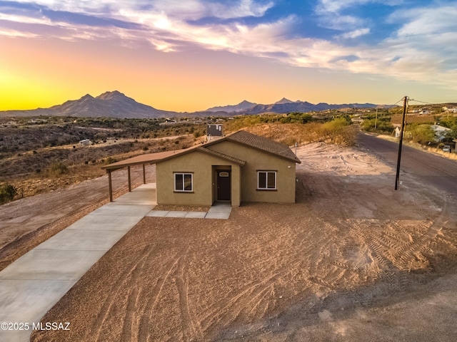 174 Via Casa, Rio Rico, AZ 85648 - view of front facade with stucco siding, a mountain view, driveway, and a carport