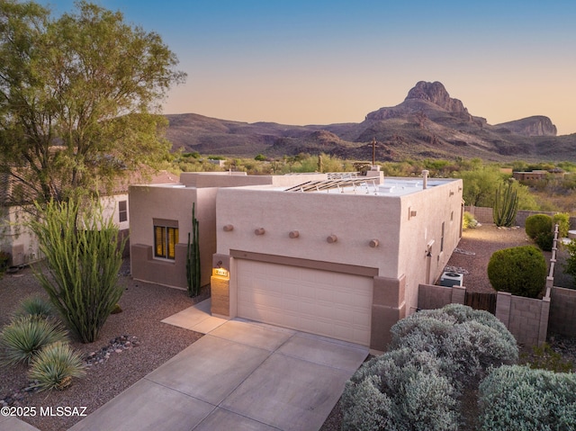 8183 N Sombrero Point Dr, Tucson, AZ 85743 - southwest-style home with stucco siding, a mountain view, driveway, and a garage