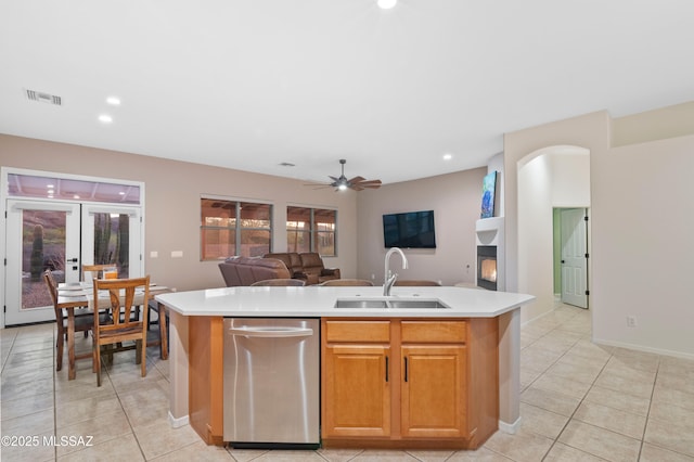 8183 N Sombrero Point Dr, Tucson, AZ 85743 - kitchen featuring open floor plan, light tile patterned floors, light countertops, stainless steel dishwasher, and a kitchen island with sink