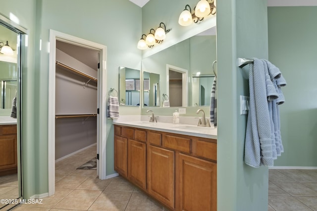 8183 N Sombrero Point Dr, Tucson, AZ 85743 - bathroom with double vanity, tile patterned flooring, and a walk in closet