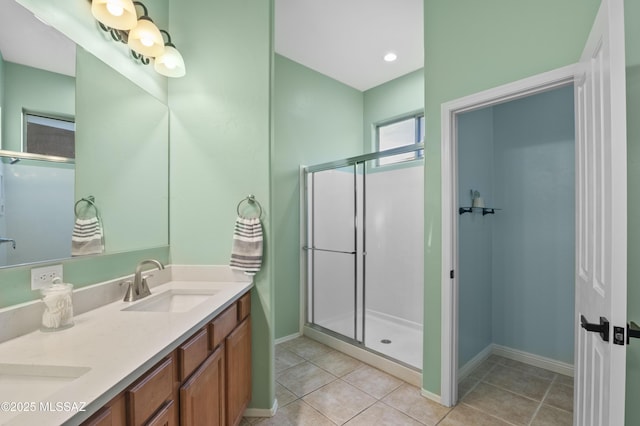 8183 N Sombrero Point Dr, Tucson, AZ 85743 - full bathroom featuring double vanity, a stall shower, and tile patterned floors