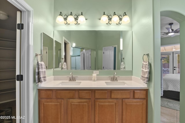 8183 N Sombrero Point Dr, Tucson, AZ 85743 - bathroom featuring connected bathroom, double vanity, ceiling fan, and a shower with shower door