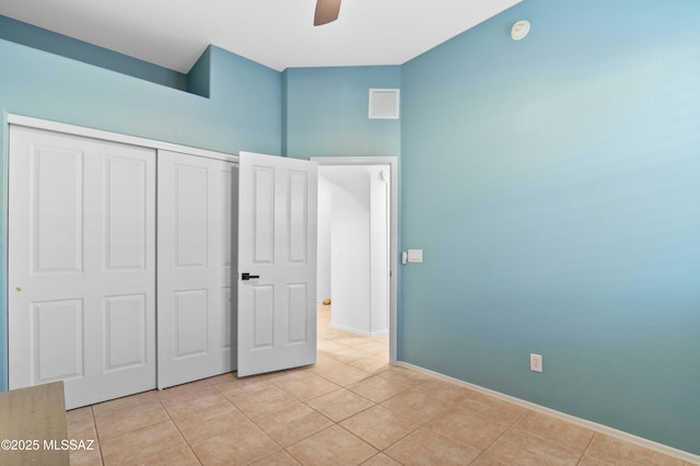 8183 N Sombrero Point Dr, Tucson, AZ 85743 - unfurnished bedroom featuring light tile patterned floors, a closet, and a ceiling fan