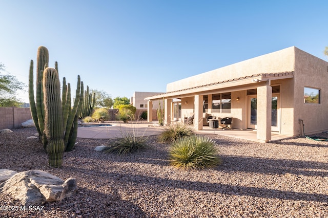 8183 N Sombrero Point Dr, Tucson, AZ 85743 - back of house with a patio area, stucco siding, and an outdoor living space