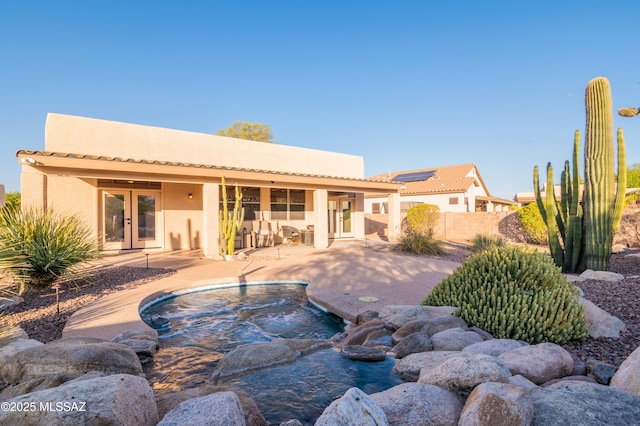 8183 N Sombrero Point Dr, Tucson, AZ 85743 - rear view of property with french doors, stucco siding, a patio, and an in-ground hot tub