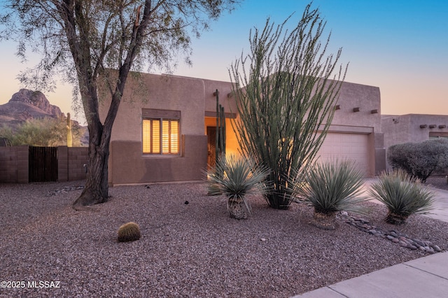 8183 N Sombrero Point Dr, Tucson, AZ 85743 - pueblo revival-style home with an attached garage and stucco siding