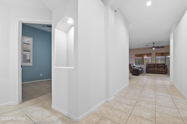 8183 N Sombrero Point Dr, Tucson, AZ 85743 - hallway featuring light tile patterned floors, plenty of natural light, and arched walkways