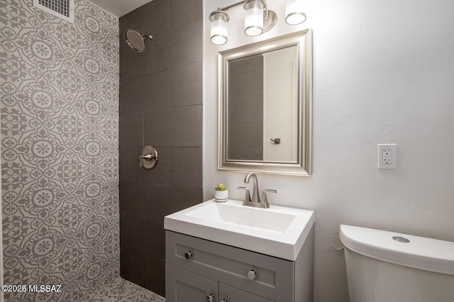 3409 E Linden St, Tucson, AZ 85716 - bathroom with vanity, tiled shower, and toilet