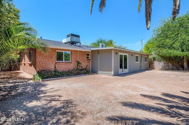 3409 E Linden St, Tucson, AZ 85716 - back of house featuring cooling unit, a patio, and brick siding
