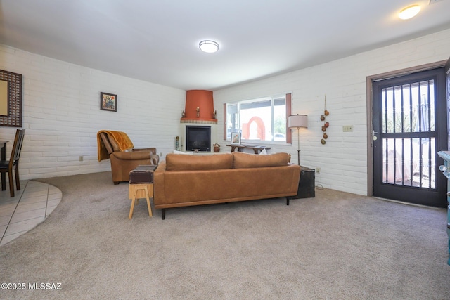 628 Corpino De Pecho, Green Valley, AZ 85614 - carpeted living room with brick wall and a fireplace