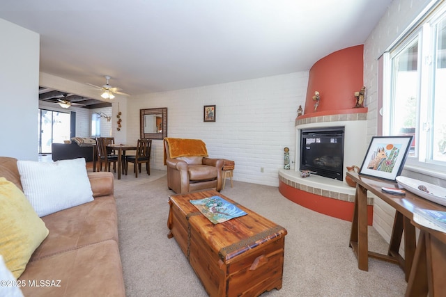 628 Corpino De Pecho, Green Valley, AZ 85614 - carpeted living area featuring a fireplace, brick wall, and a ceiling fan