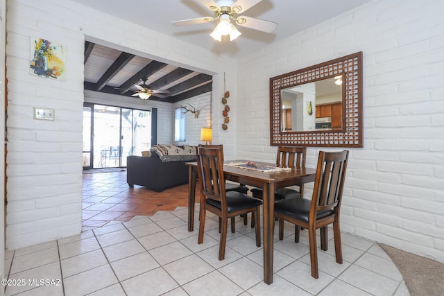 628 Corpino De Pecho, Green Valley, AZ 85614 - dining space with brick wall, beamed ceiling, a ceiling fan, and light tile patterned floors