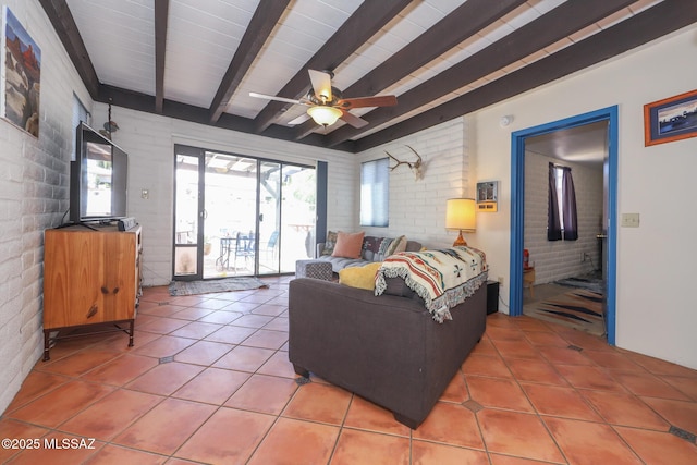 628 Corpino De Pecho, Green Valley, AZ 85614 - living area featuring light tile patterned floors, beamed ceiling, brick wall, and ceiling fan