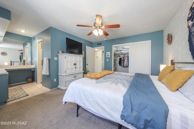 628 Corpino De Pecho, Green Valley, AZ 85614 - bedroom featuring a closet, light colored carpet, a ceiling fan, light tile patterned floors, and ensuite bath