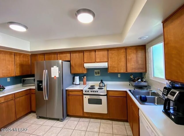 628 Corpino De Pecho, Green Valley, AZ 85614 - kitchen featuring appliances with stainless steel finishes, a sink, under cabinet range hood, and brown cabinets