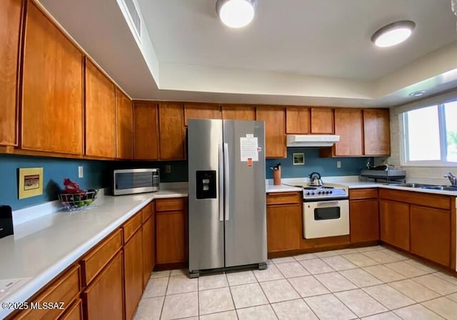 628 Corpino De Pecho, Green Valley, AZ 85614 - kitchen featuring appliances with stainless steel finishes, under cabinet range hood, brown cabinetry, and a sink