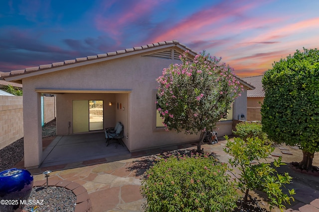 5590 W Acacia Blossom Pl, Marana, AZ 85658 - back of property at dusk featuring a patio area and stucco siding