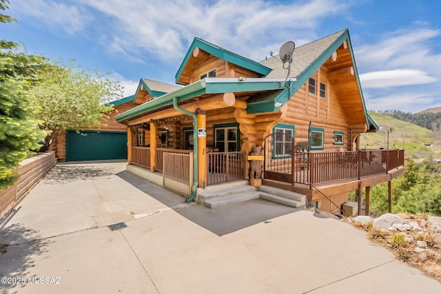 12709 N Casa Grande Ave, Mount Lemmon, AZ 85619 - cabin featuring a porch, log siding, and a garage