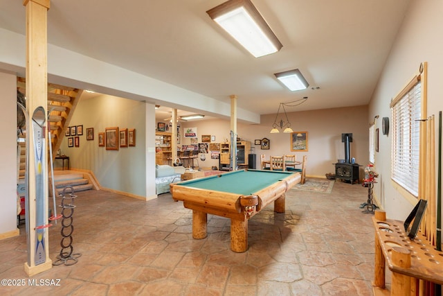 12709 N Casa Grande Ave, Mount Lemmon, AZ 85619 - game room with light stone finish flooring, a wood stove, billiards table, and baseboards