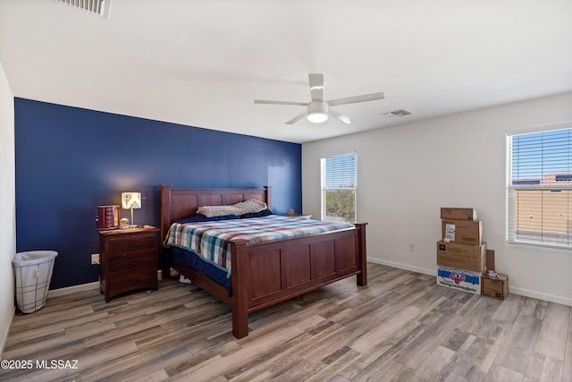 6494 E Brushback Loop, Tucson, AZ 85756 - bedroom featuring light wood-type flooring, baseboards, and ceiling fan