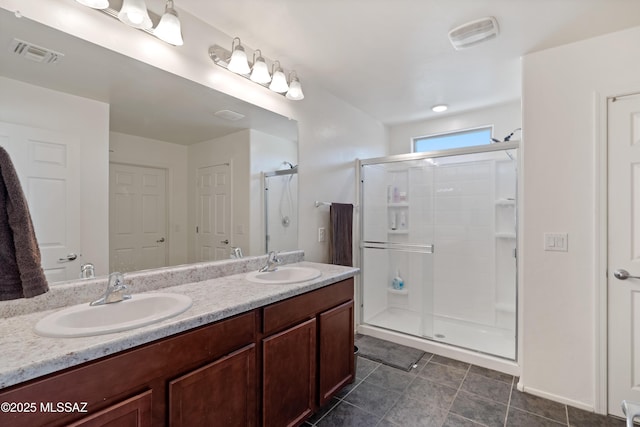 6494 E Brushback Loop, Tucson, AZ 85756 - bathroom featuring a shower stall, double vanity, and tile patterned flooring