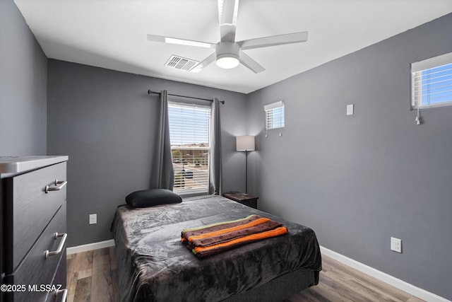 6494 E Brushback Loop, Tucson, AZ 85756 - bedroom featuring wood finished floors, baseboards, and ceiling fan
