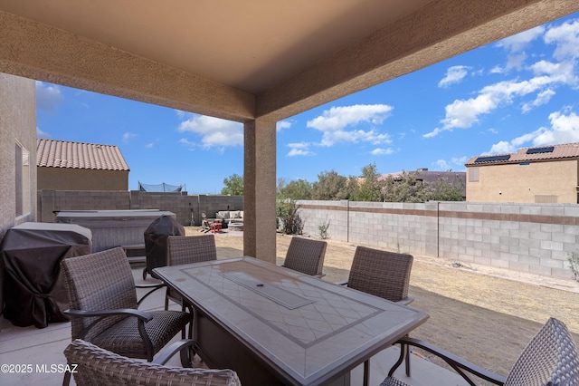 6494 E Brushback Loop, Tucson, AZ 85756 - view of patio / terrace featuring a hot tub, outdoor dining area, a fenced backyard, and area for grilling