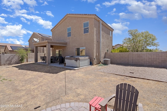 6494 E Brushback Loop, Tucson, AZ 85756 - back of property with a hot tub, a fenced backyard, a patio, stucco siding, and cooling unit