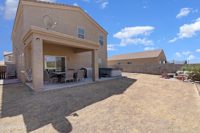 6494 E Brushback Loop, Tucson, AZ 85756 - rear view of property with a hot tub, a patio area, stucco siding, and a fenced backyard