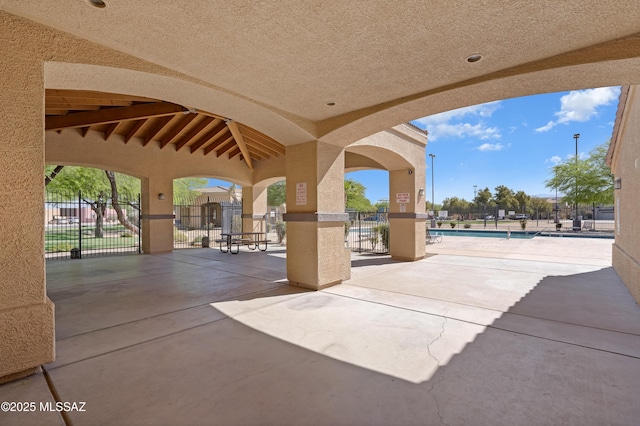 6494 E Brushback Loop, Tucson, AZ 85756 - view of patio featuring fence and a community pool