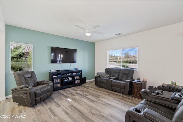 6494 E Brushback Loop, Tucson, AZ 85756 - living area featuring light wood-type flooring, ceiling fan, and baseboards