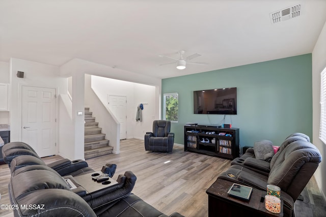 6494 E Brushback Loop, Tucson, AZ 85756 - living area with light wood-style floors, ceiling fan, and stairs