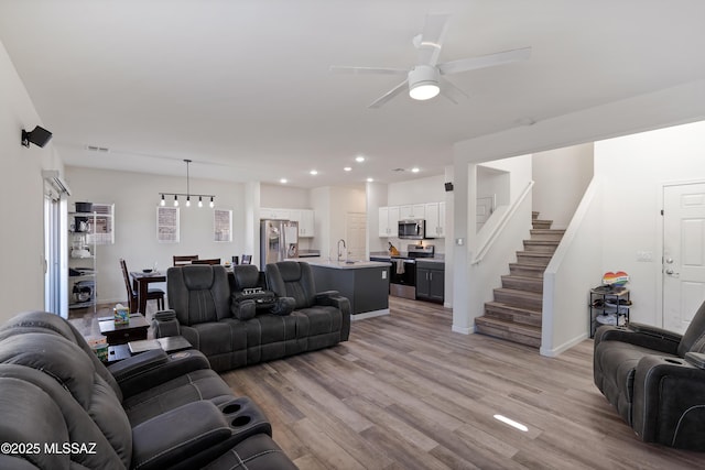 6494 E Brushback Loop, Tucson, AZ 85756 - living area featuring stairway, ceiling fan, light wood-style flooring, recessed lighting, and baseboards