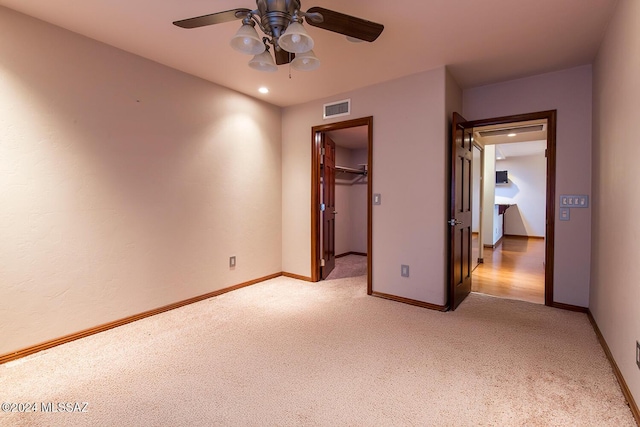 6864 E Via Dorado, Tucson, AZ 85715 - unfurnished bedroom with light colored carpet, baseboards, a spacious closet, ceiling fan, and a closet