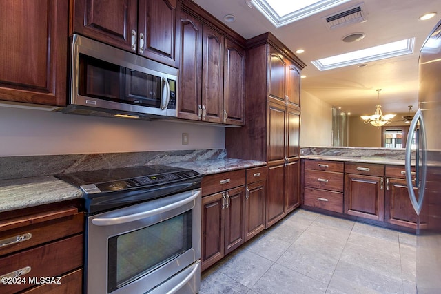 6864 E Via Dorado, Tucson, AZ 85715 - kitchen with appliances with stainless steel finishes, light tile patterned floors, a chandelier, decorative light fixtures, and light stone countertops