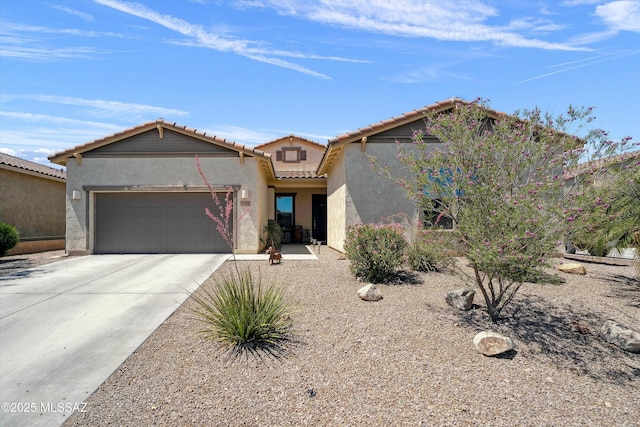 5920 W Yuma Mine Cir, Tucson, AZ 85743 - view of front of property with an attached garage, stucco siding, a tiled roof, and concrete driveway