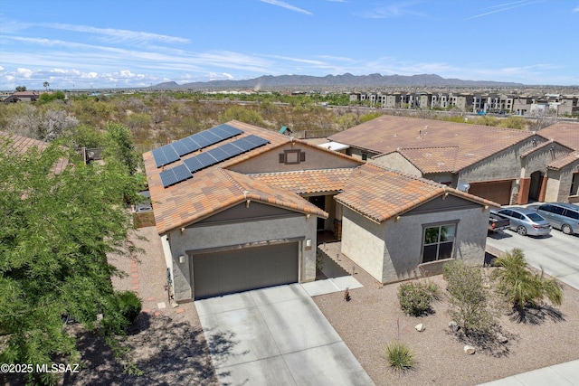 5920 W Yuma Mine Cir, Tucson, AZ 85743 - mediterranean / spanish house with stucco siding, an attached garage, concrete driveway, solar panels, and a tiled roof